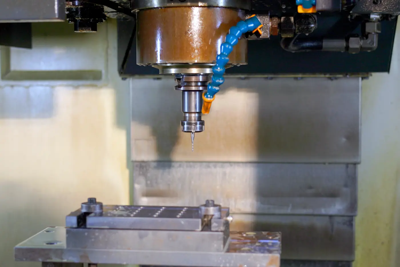 A machining centre cutting a fixture, coolant running